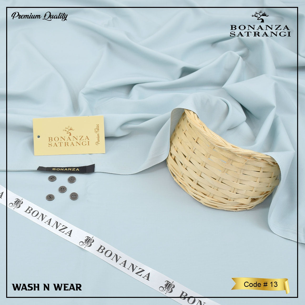 Light blue fabric with Bonanza Satrangi branding, a basket, buttons, and a ribbon on a light gray background.